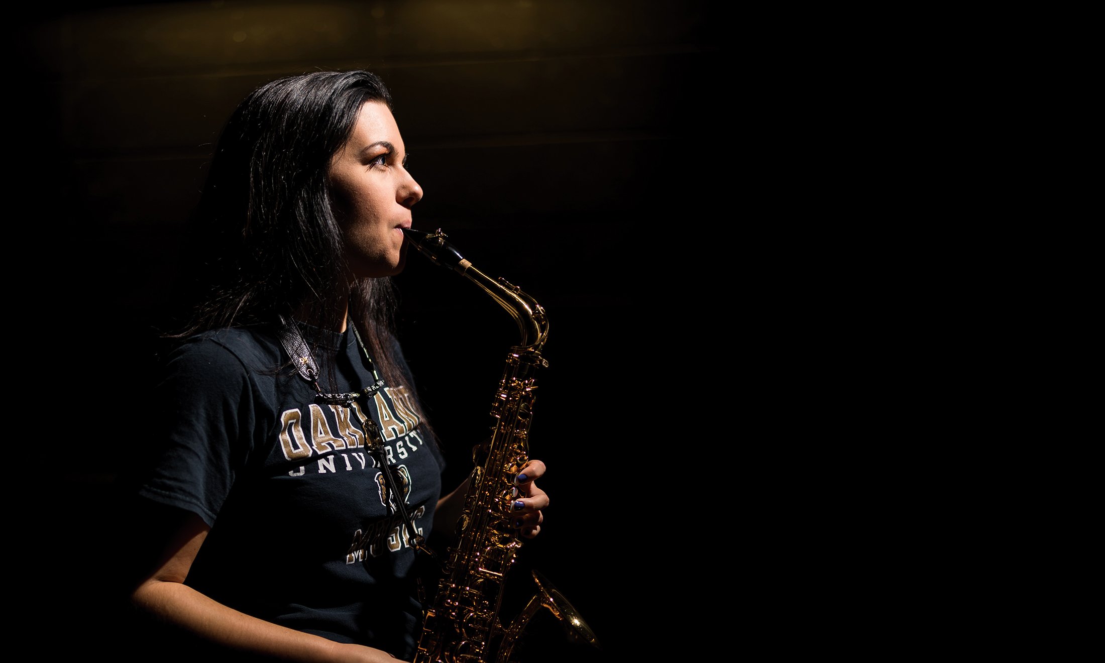 A woman playing a saxophone.