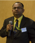 Amitava Adhikary holding a microphone.