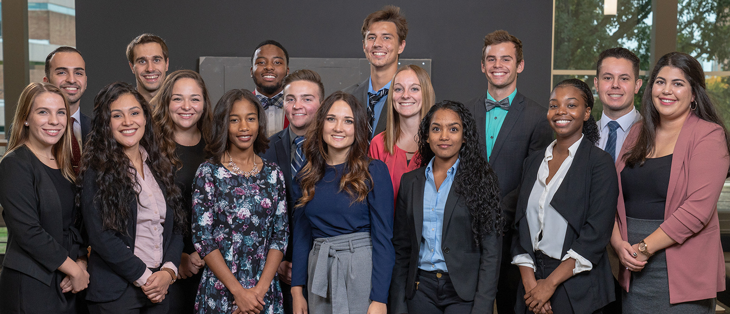 group photo of young adults in business professional attire