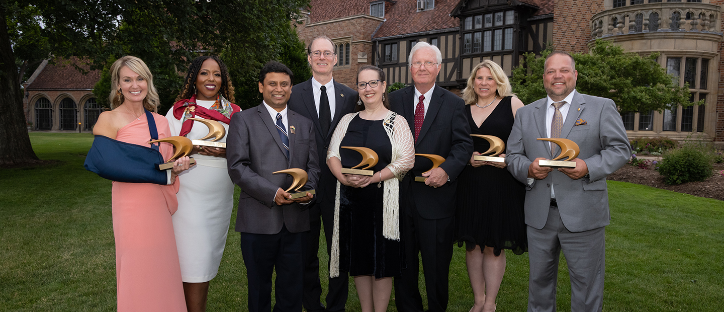 The winners of the Alumni Awards holding their awards