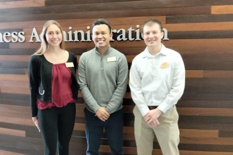 Mariella Simoncini, Porfirio Garcia and Jesse Bischer posing for a photo at the Business Scholars case competition.