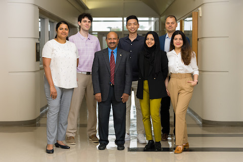 Data analytics student and Dr. Sugumaran pose for a group photo.