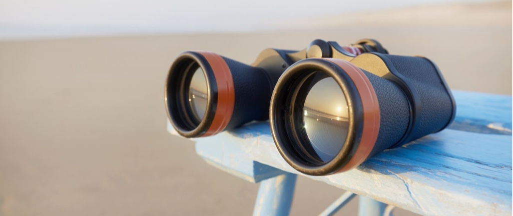 Binoculars on a bench at the beach