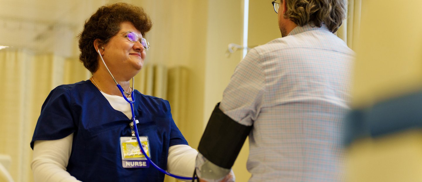 A nurse taking a man's blood pressure.