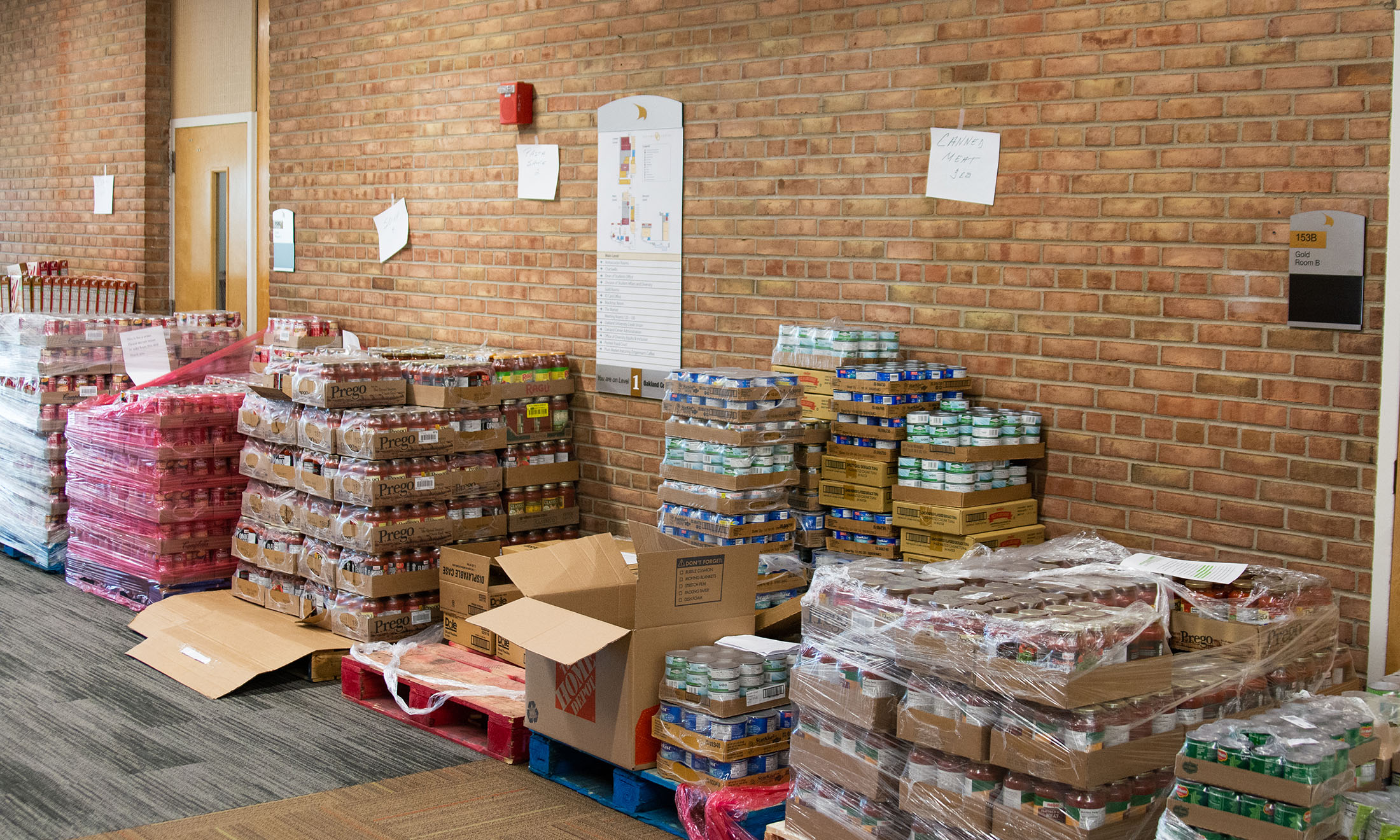 Boxes of food stacked along wall in building