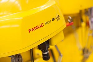 Industrial yellow robot with FANUC logo