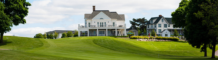 image of the back of the Steve Sharf Clubhouse building from the perspective of the greens