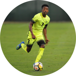 man in a bright yellow uniform playing soccer