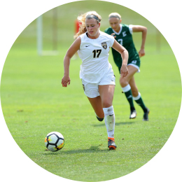 two young women playing soccer