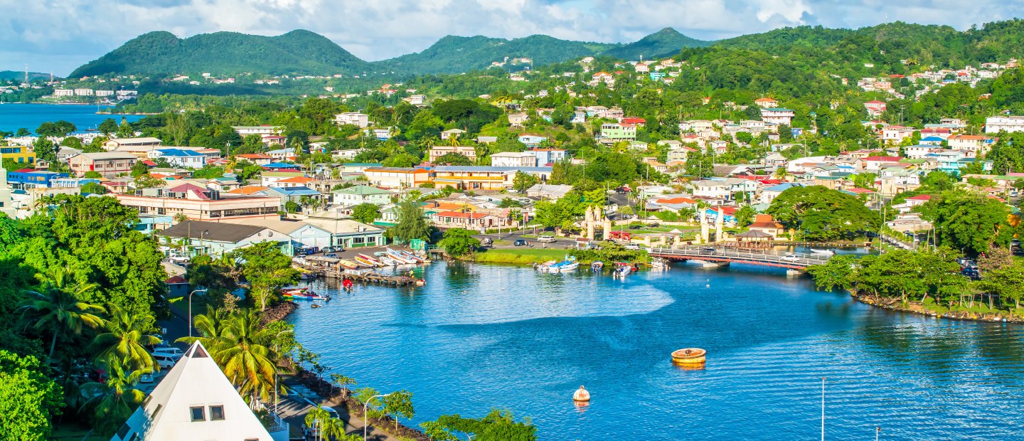 An aerial photo of buildings, water and mountains in St. Lucia.