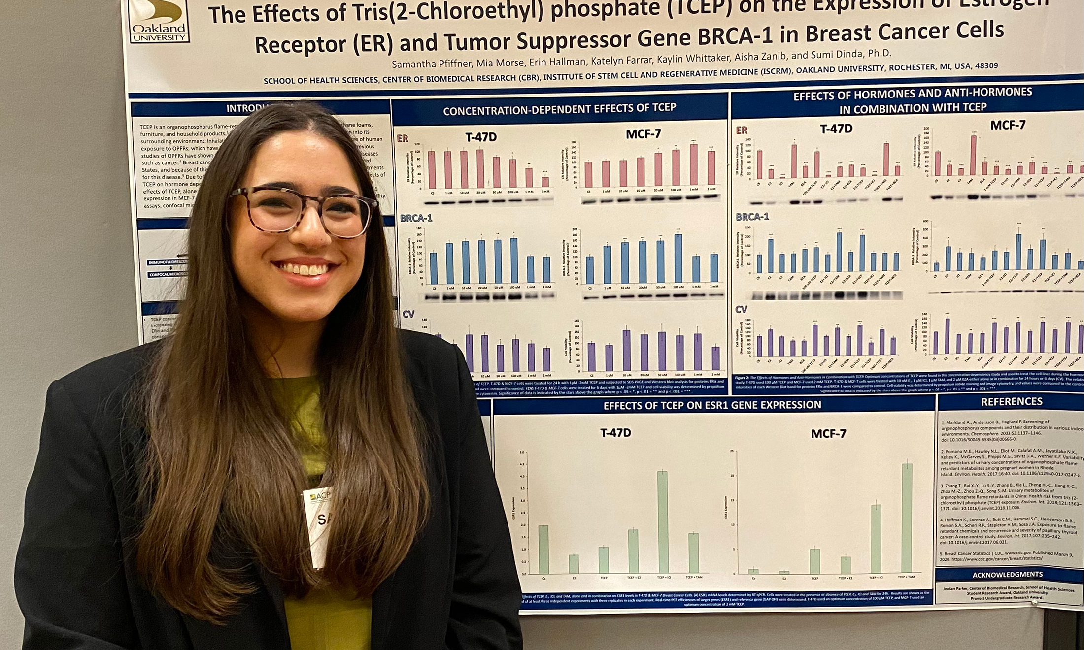 Samantha Pfiffner stands in front of her research poster