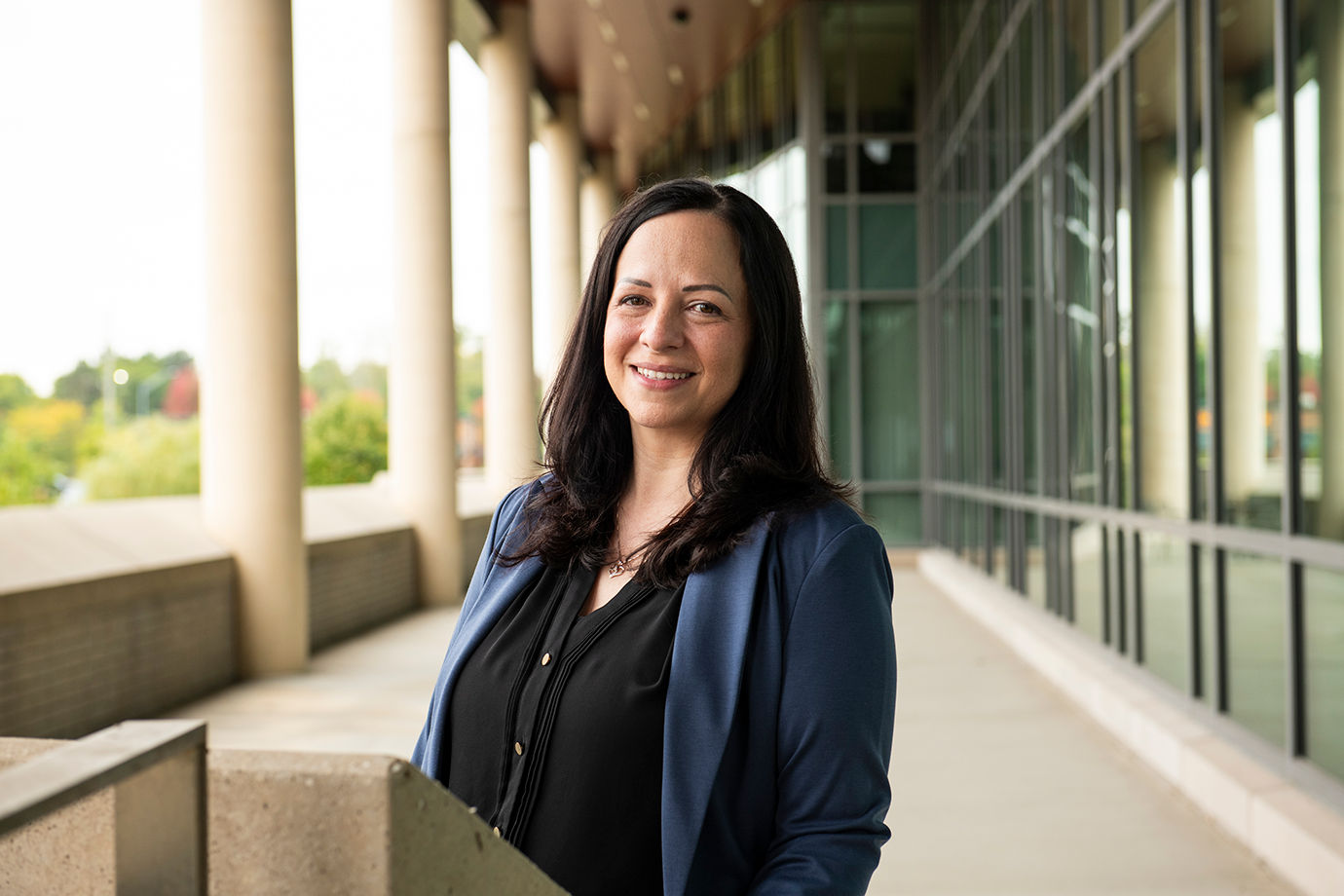 Sara Rivard proudly smiles outside of the Human Health Building