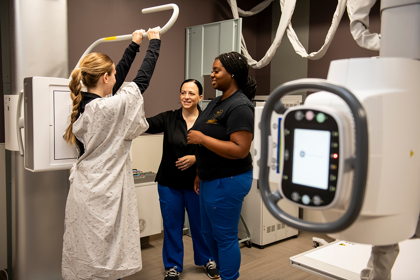 Sara Rivard demonstrates how to position a patient for an x-ray