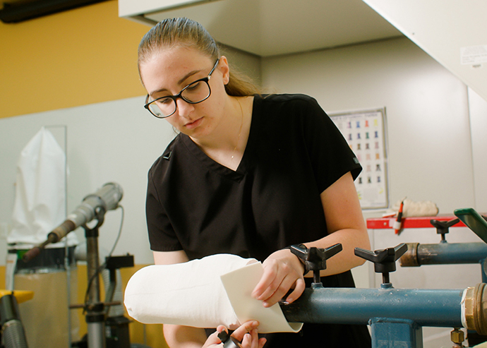 Julie Czech works on a prosthesis in a lab