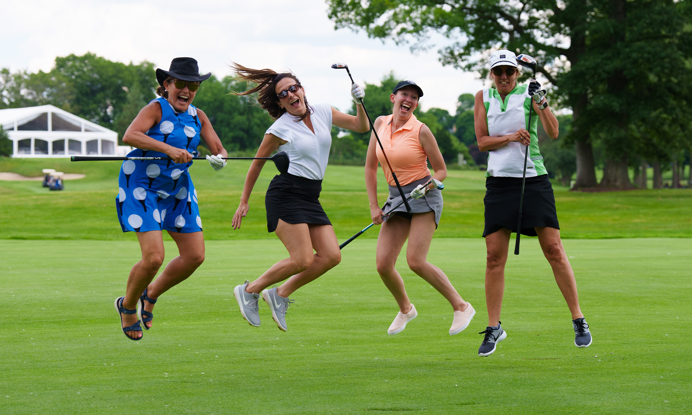 An image of a group of golfers jumping