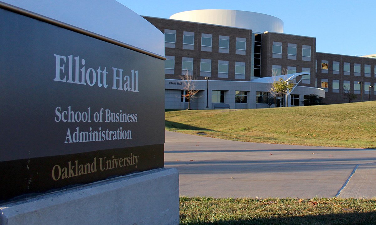 Exterior photo of building and sign. Sign reads Elliott Hall School of Business Administration. 