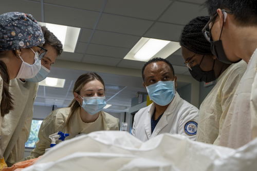An image of FMS faculty in the anatomy lab with students
