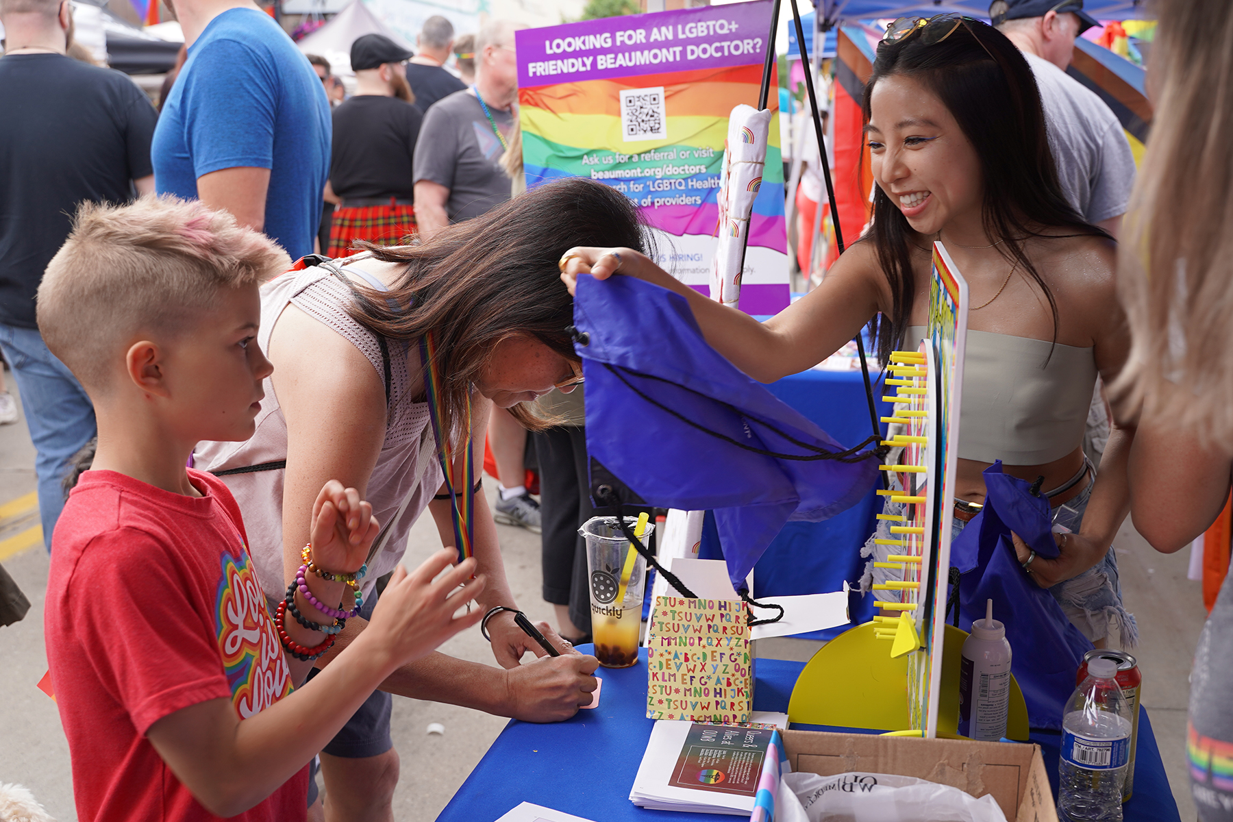 An OUWB student hands out prizes during Pride 22 in Ferndale.