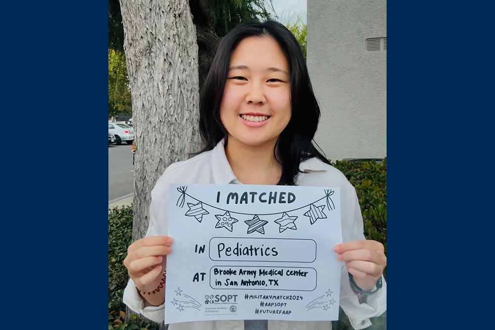 An image of Nikita Lee holding a sign showing where she matched