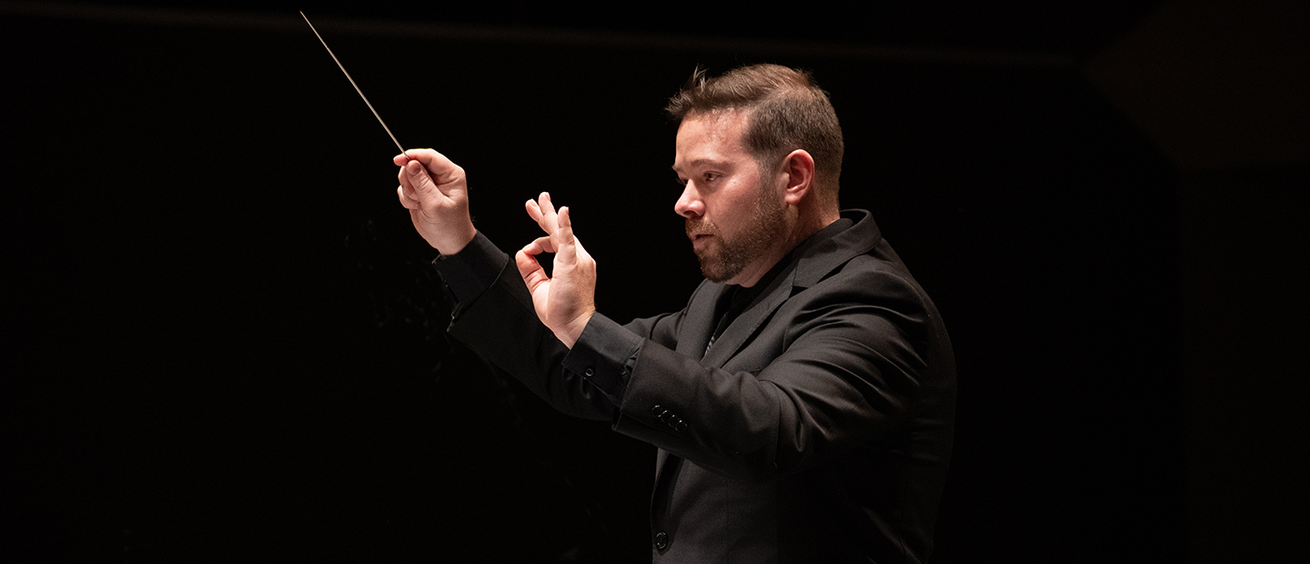 Man conducting on stage
