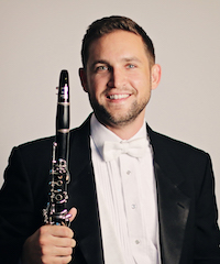 A professional photo of Ralph Skiano holding a clarinet.