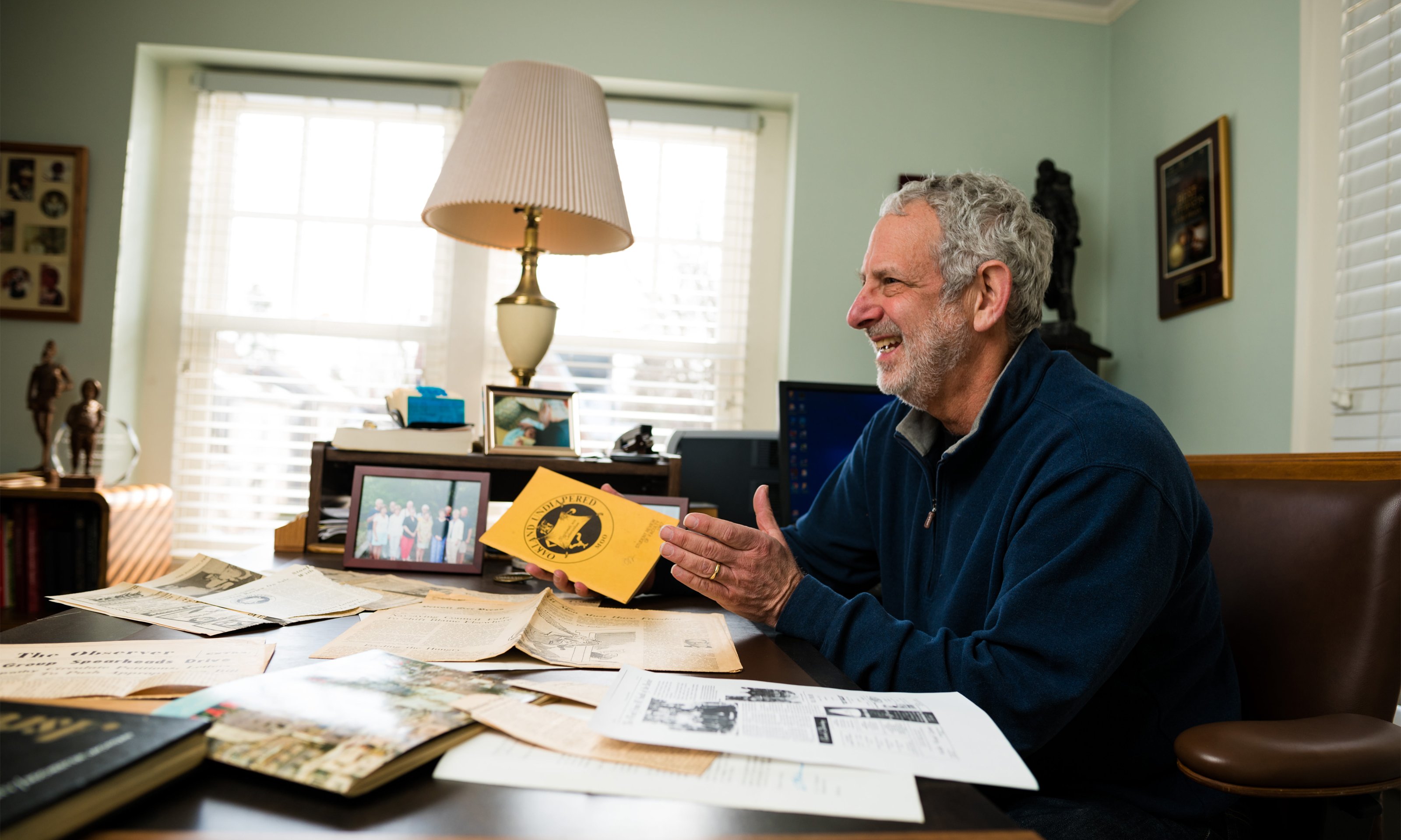 Oakland University alumnus Marty Reisig looks over papers from his days as a student 