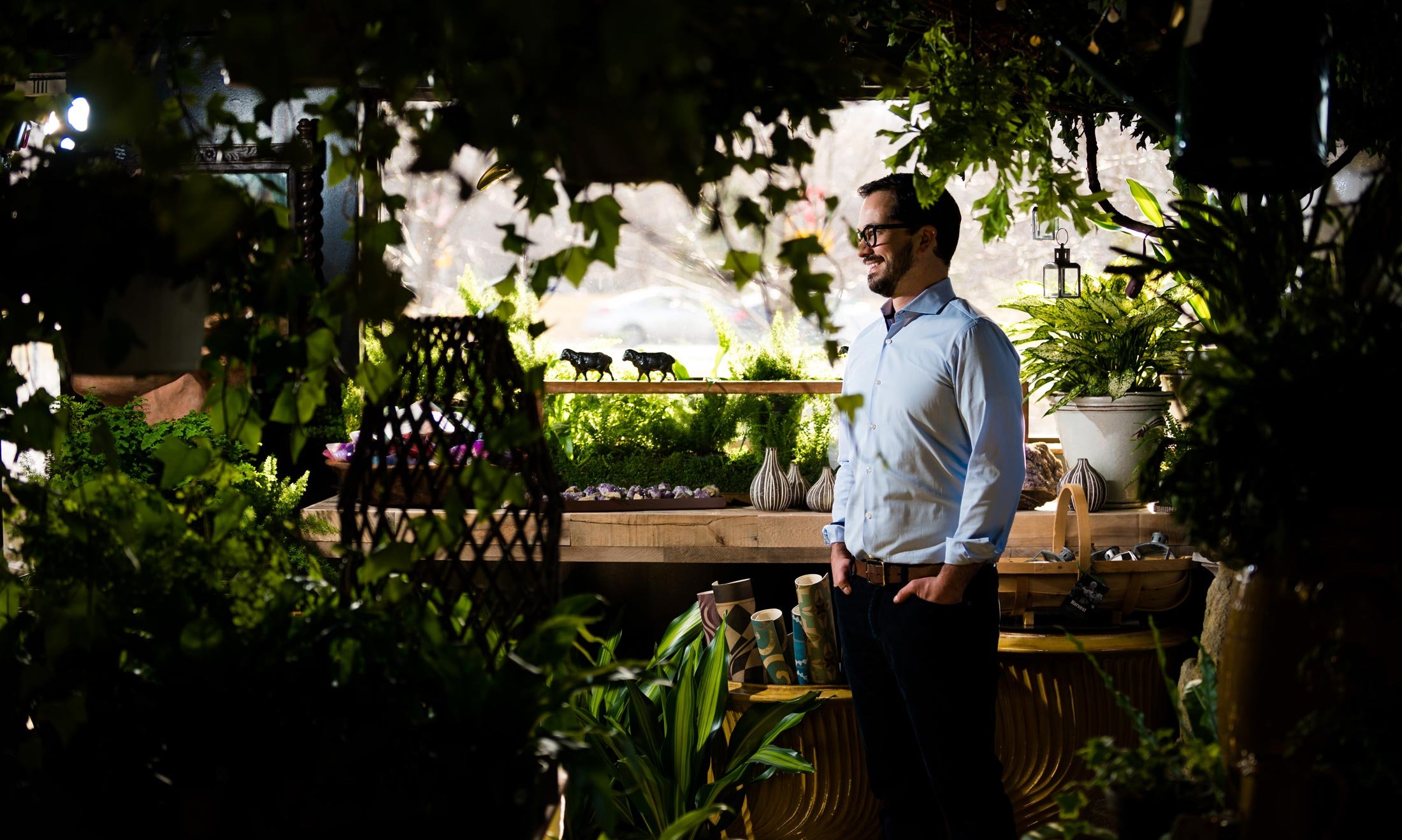 Phillip Morici inside the Garden Shoppe at fleurdetroit - Standing in front of workbench