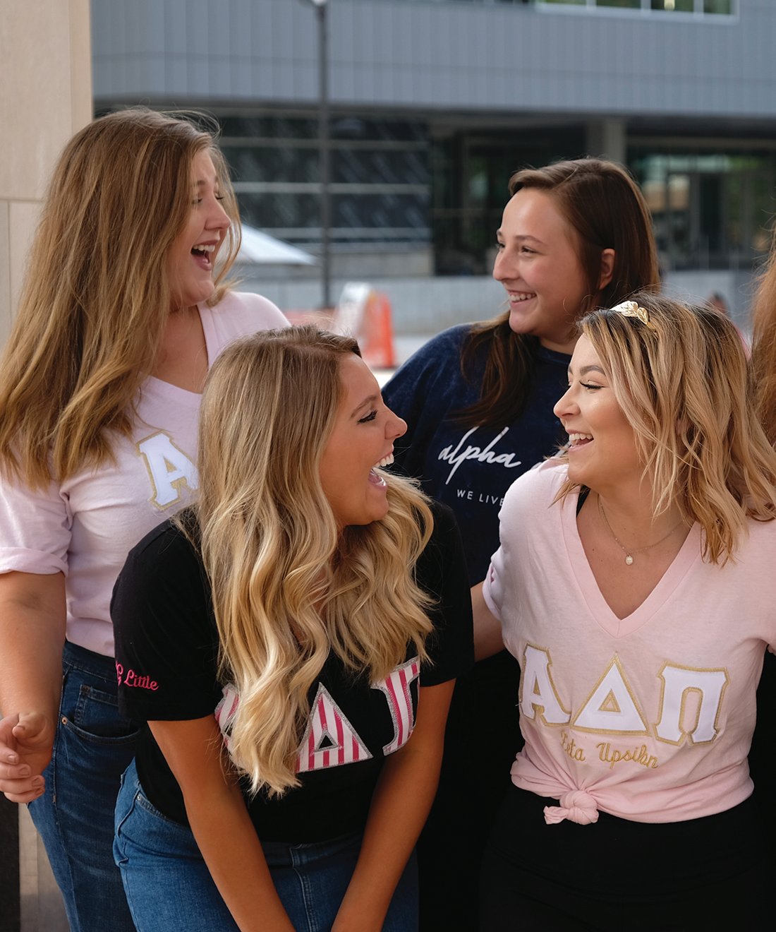 Four members of Alpha Delta Pi sorority laughing and smiling