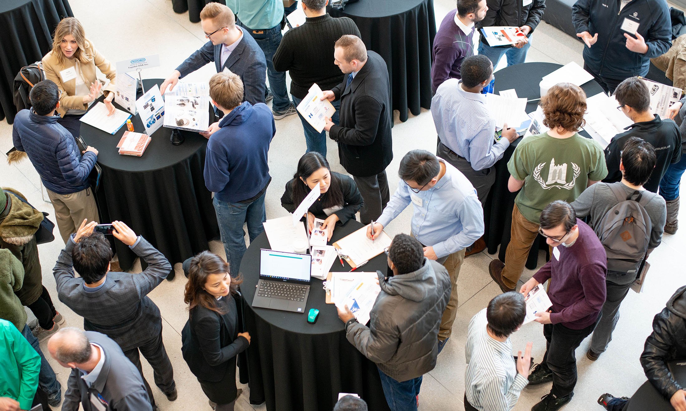 overhead image of event tables with people standing around them