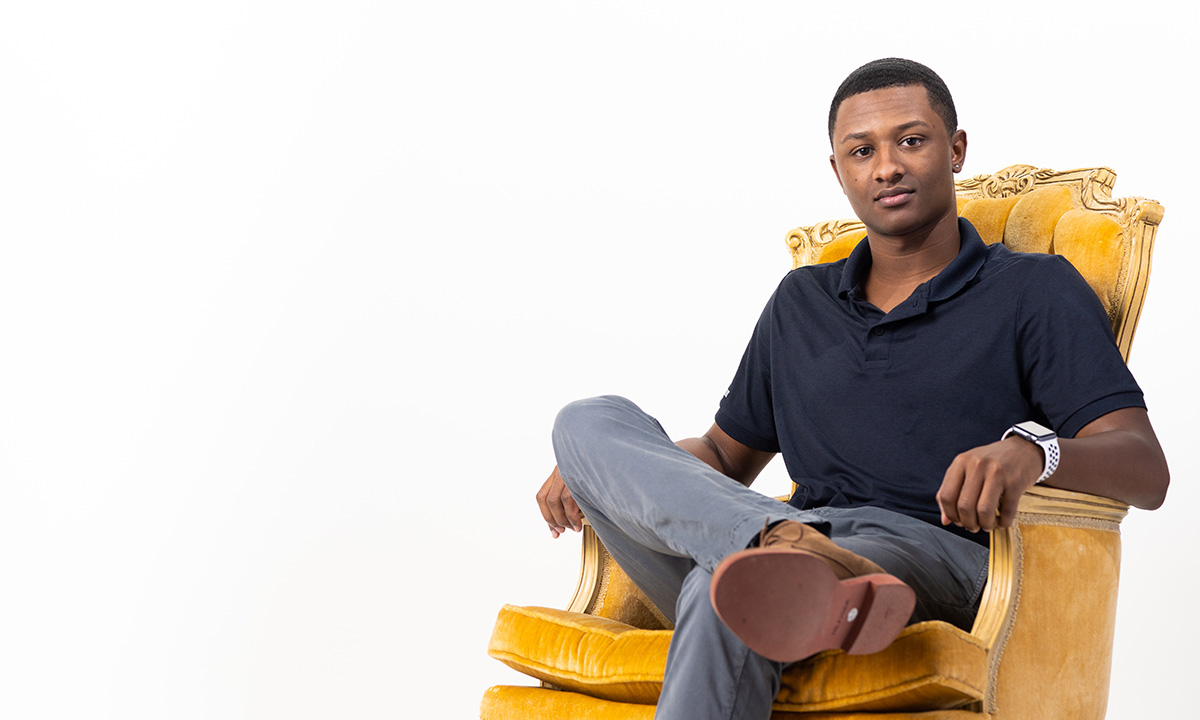Student sitting in gold chair