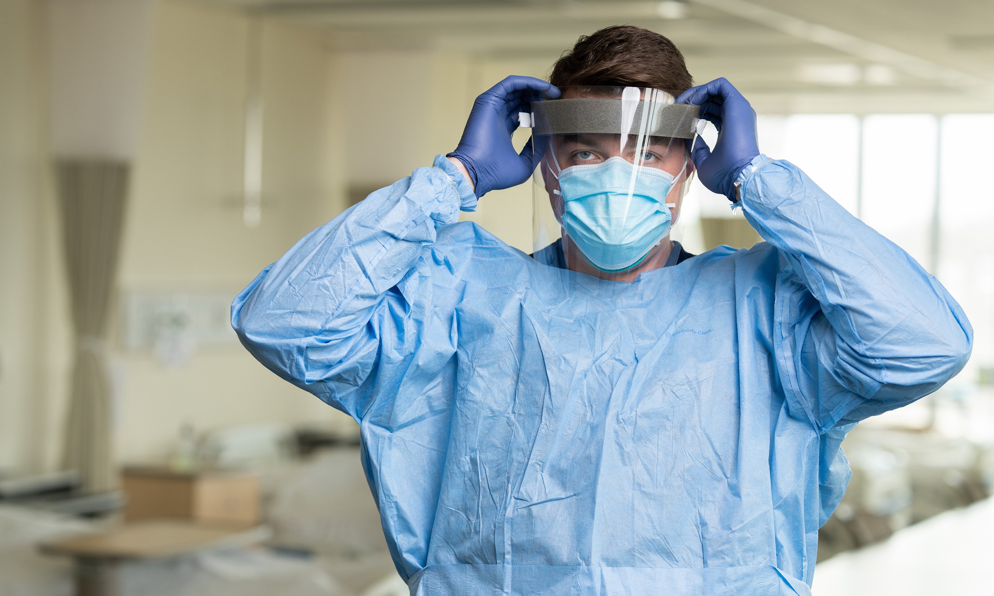 A male nurse in full PPE.