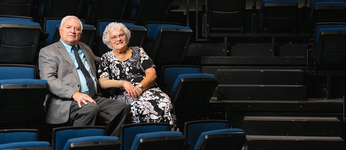 Man and woman sitting in theatre seats