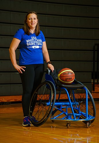 Women with basketball on wheelchair