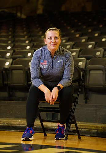 Woman sitting in chair on basketball court