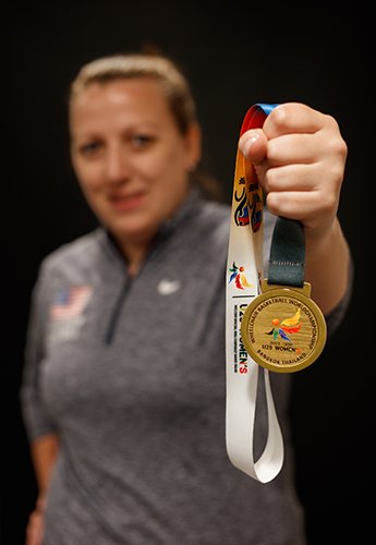 Woman holding paralympic medal