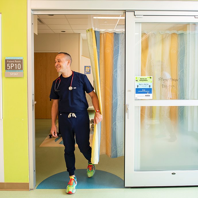 Man walking out of hospital room