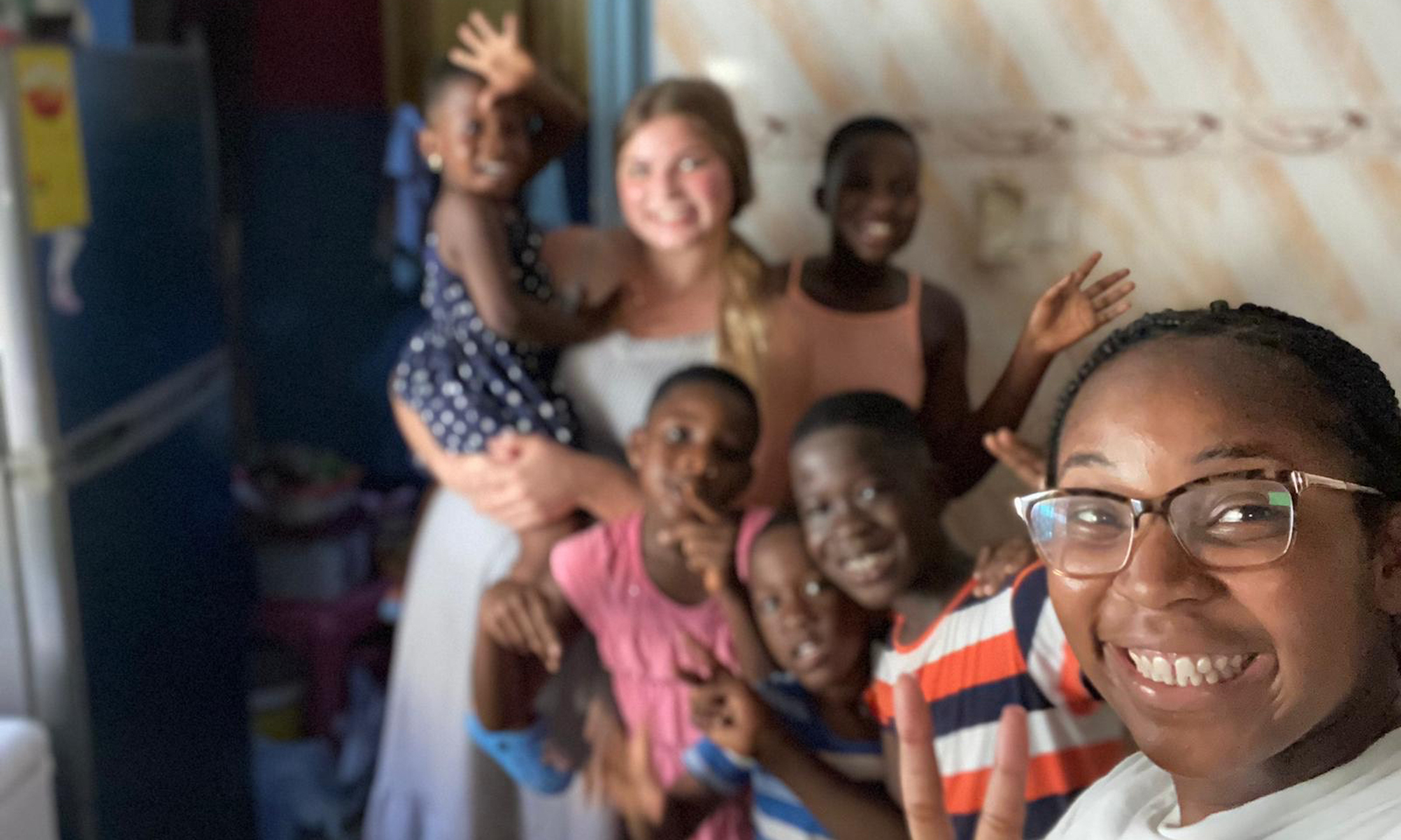 OU students take a selfie with children in Ghana