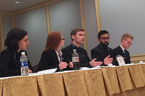 Nick Fontana (center) proposes an argument as team members Genevieve Schmidt, Samantha Sinclair, Hamza Ahmed, and Ian Anderson (left to right) look on. 