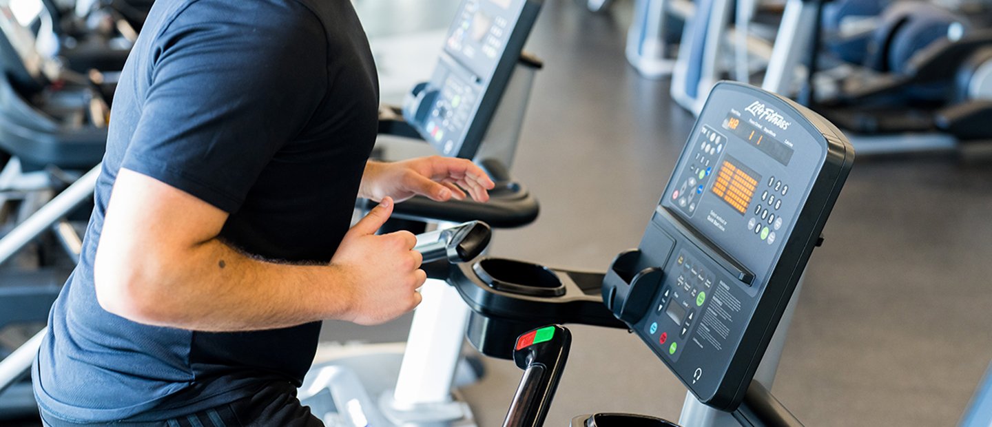 A person working out on cardio equipment at the Recreation Center.