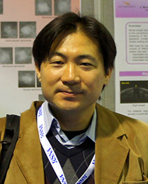 Photo of Kenji Suzuki in a tan jacket
