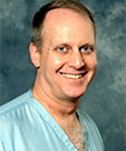 A headshot of Brian Mason, wearing scrubs.