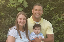 portrait image of Chase and Jessica Salazar and their child