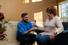 image of a man helping a woman improve her hand grip through physical therapy
