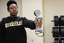 image of a girl in a Golden Grizzlies sweatshirt holding a diabetes research tool