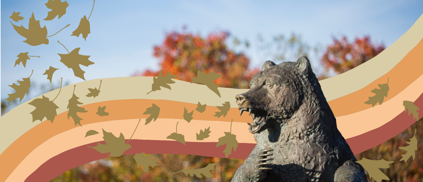 Statue of the Grizzly Bear on Oakland University's campus with illustrated rainbow and gold leaves