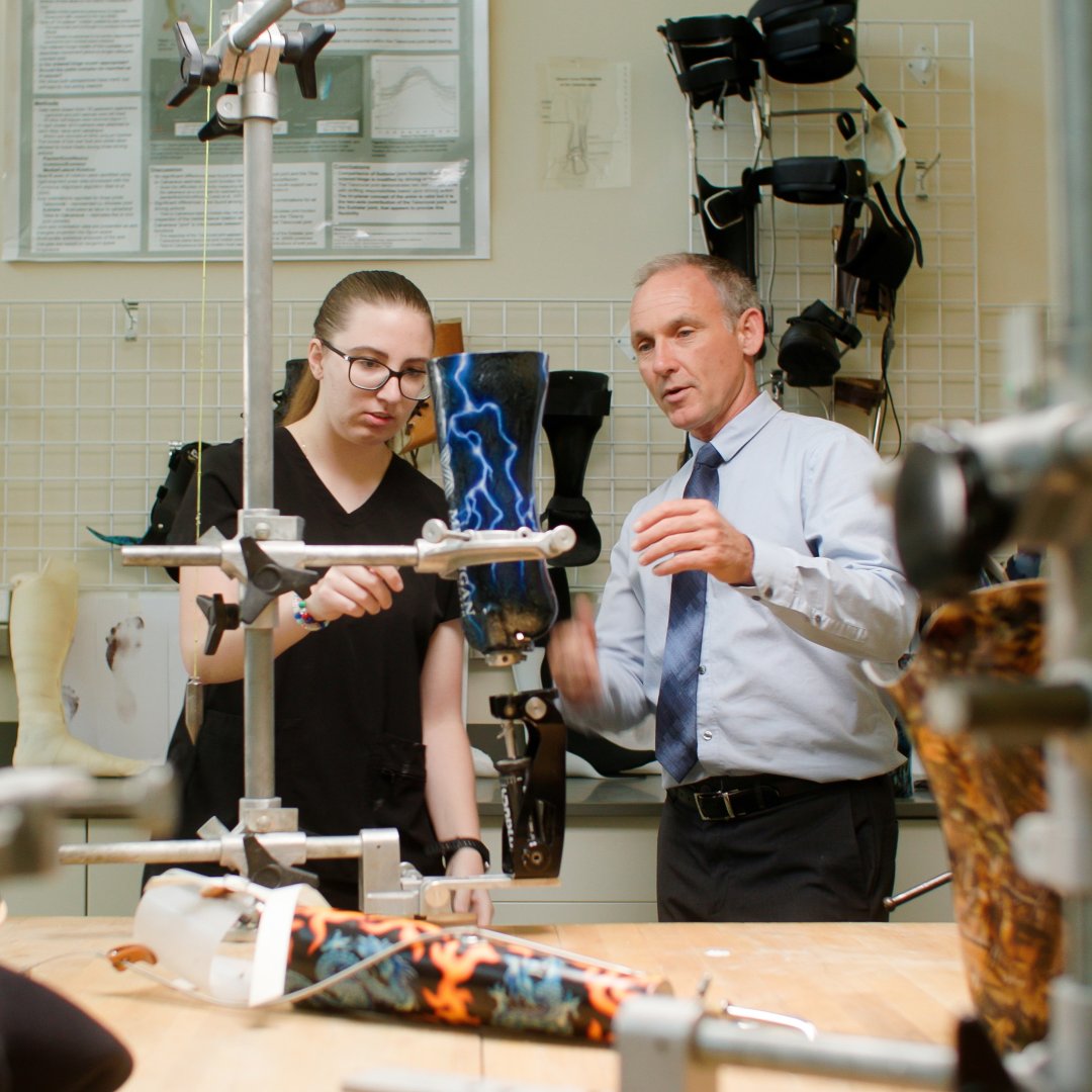 A student and professor in an orthotic/prosthetic lab.