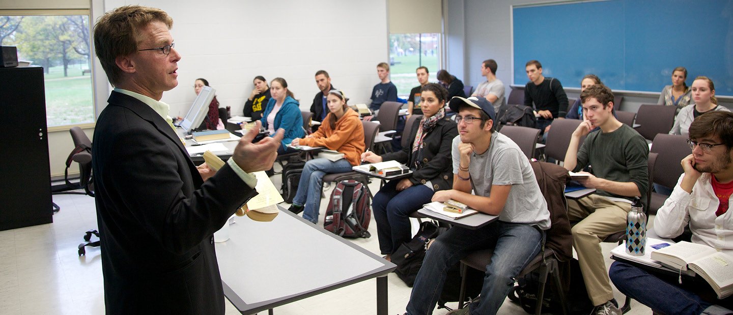 A professor taking a full classroom of students.