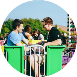 Two men on a green carnival ride