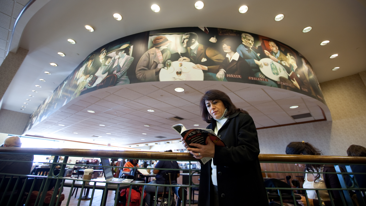 Dunya Mikhail reading magazine