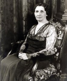 Black and white photo of Matilda Dodge Wilson sitting in an ornate chair.